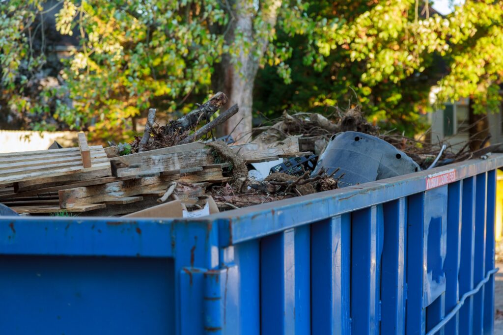 Industrial dumpster filled Loaded dumpster near a construction site, home renovation